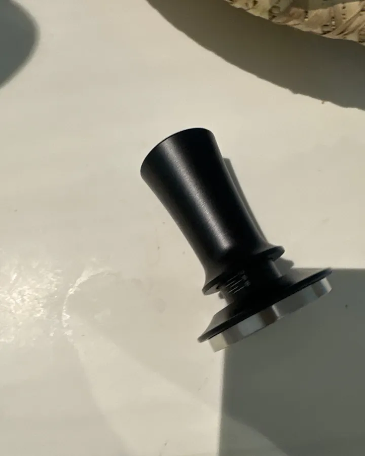 Calibrated coffee tamper photographed at home by a verified buyer — Straight 51mm