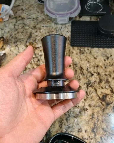 Calibrated coffee tamper photographed at home by a verified buyer — Straight 58mm