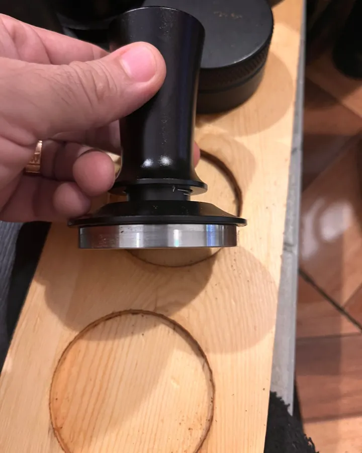 Calibrated coffee tamper photographed at home by a verified buyer — Straight 58mm