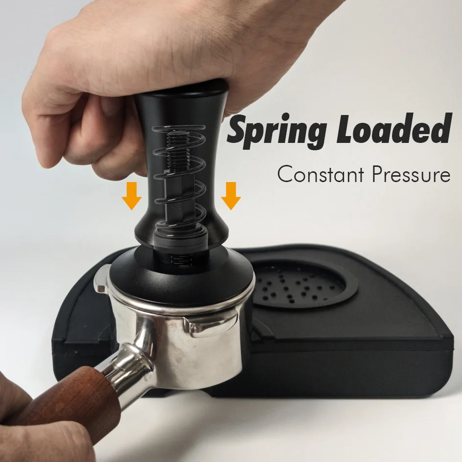 Spring-loaded coffee tamper pressed into a portafilter, the spring compressed under the handle