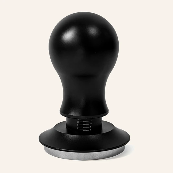 Calibrated tamper with a rounded handle, matte black over a stainless base
